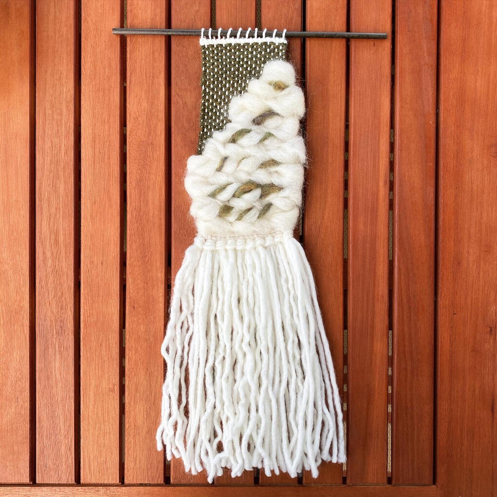A textural green yarn and undyed roving weaving.