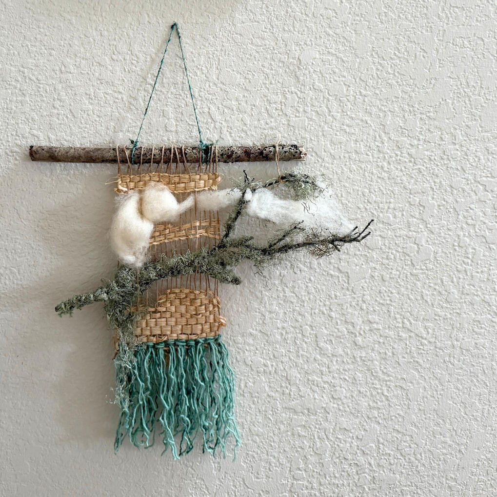 Natural fiber weaving that incorporates a foggy branch.